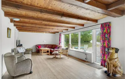 a living room with white walls and a wooden ceiling at Holiday Home Årup Byvej in Snedsted