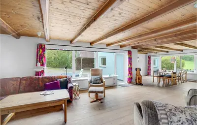 a living room with a couch and a table at Holiday Home Årup Byvej in Snedsted