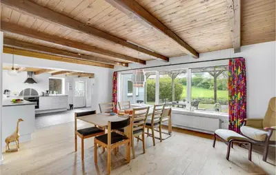 a kitchen and dining room with a table and chairs at Holiday Home Årup Byvej in Snedsted