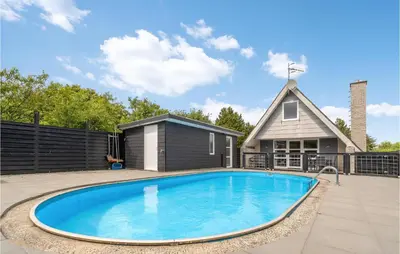 a swimming pool in front of a house at Nice Home In Vestervig With Wifi in Vestervig