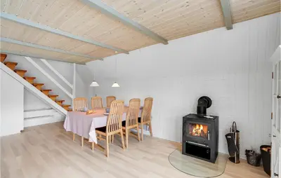 a dining room with a table and a wood stove at Nice Home In Vestervig With Wifi in Vestervig