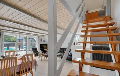 a living room with a staircase and a dining room at Nice Home In Vestervig With Wifi in Vestervig