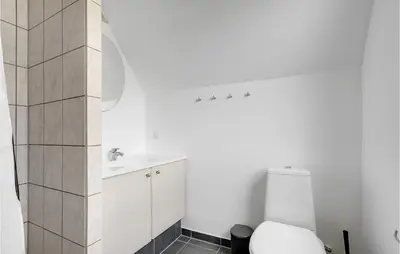 a white bathroom with a toilet and a sink at Nice Home In Vestervig With Wifi in Vestervig