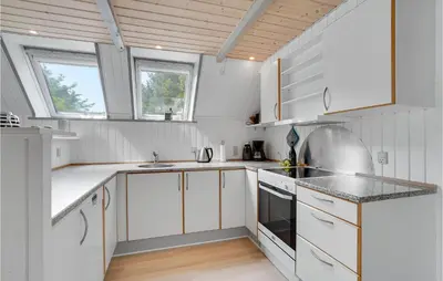 a white kitchen with white cabinets and windows at Nice Home In Vestervig With Wifi in Vestervig