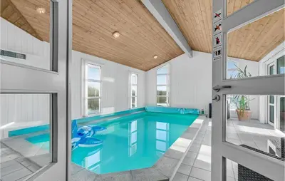 a swimming pool in the middle of a house at Stunning Home In Vestervig With Sauna in Vestervig