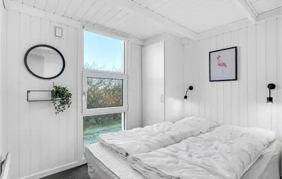 a white bedroom with a large bed and a window at Stunning Home In Vestervig With Sauna in Vestervig