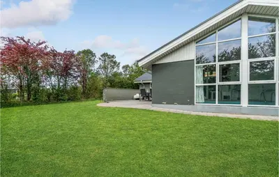 a house with a large window and a yard at 4 Bedroom Lovely Home In Vestervig in Vestervig