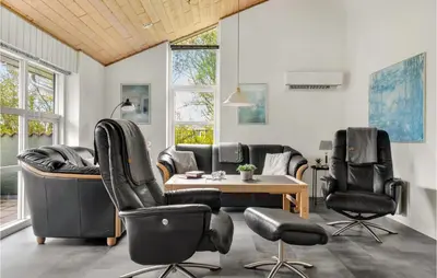 a living room with leather chairs and a table at 4 Bedroom Lovely Home In Vestervig in Vestervig
