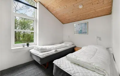 a bedroom with two beds and a window at 4 Bedroom Lovely Home In Vestervig in Vestervig