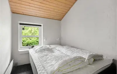 a bed in a room with a window at 4 Bedroom Lovely Home In Vestervig in Vestervig