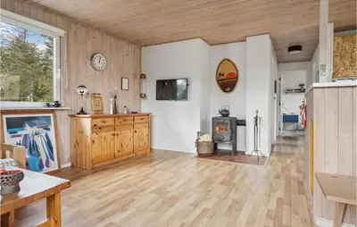 a large living room with a wood floor and a fireplace at Holiday Home Mølgårdsvej Thisted in Thisted