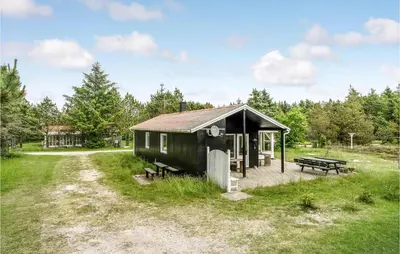a small shed with a picnic table and a bench at Holiday Home Mølgårdsvej Thisted in Thisted