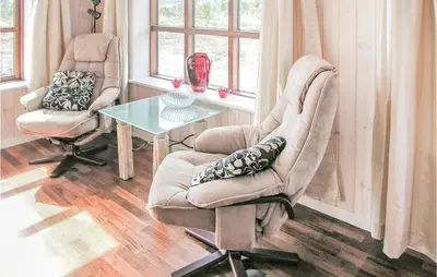 a living room with two chairs and a table at Casa Blanca in Thisted