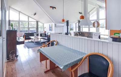 a kitchen and living room with a table and chairs at Lovely Home In Thisted With Wifi in Thisted