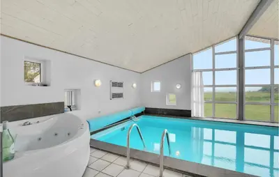 a large bathroom with a tub and a swimming pool at Beautiful Home In Vestervig With Sauna in Vestervig