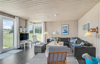 a living room with a couch and a table at Stunning Home In Thisted With Sauna in Thisted