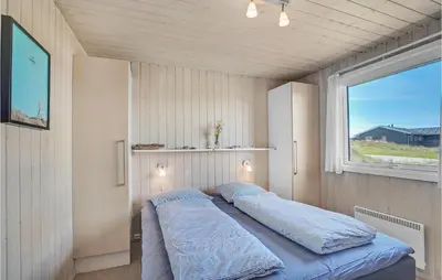 a bedroom with a bed in a room with a window at Stunning Home In Thisted With Sauna in Thisted