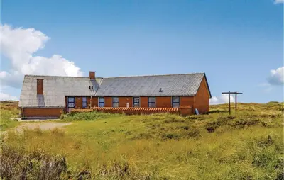 a house on top of a hill in a field at Awesome Home In Thisted With Sauna in Thisted