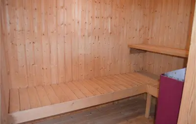 a wooden sauna with a bench in it at Awesome Home In Thisted With Sauna in Thisted