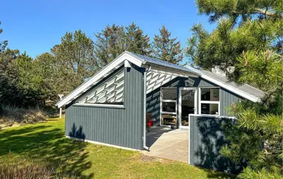 a gray garage with a large door on a lawn at Two-Bedroom Holiday Home In Thisted in Thisted
