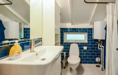 a bathroom with a white sink and a toilet at Two-Bedroom Holiday Home In Thisted in Thisted