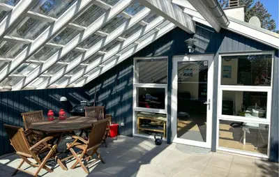 a patio with a table and chairs and a white pergola at Two-Bedroom Holiday Home In Thisted in Thisted