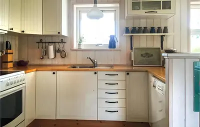 a kitchen with white cabinets and a sink and a window at Three-Bedroom Holiday Home In Thisted in Thisted