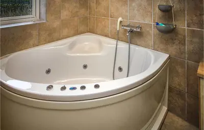 a bath tub in a bathroom with a window at Three-Bedroom Holiday Home In Thisted in Thisted