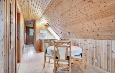 a bedroom with a bed in a wooden room at Four-Bedroom Holiday Home In Thisted in Thisted