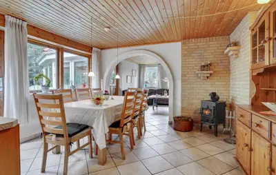 a kitchen and dining room with a table and chairs at Four-Bedroom Holiday Home In Thisted in Thisted