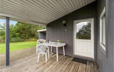 a patio with a table and chairs on a deck at Holiday Home Klemsvej in Thisted