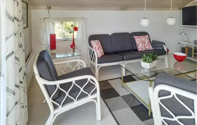 a living room with a couch and a glass table at Holiday Home Grårisvej Thisted V in Thisted