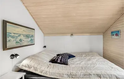 a bed in a room with a wooden ceiling at Holiday Home Grårisvej Thisted V in Thisted