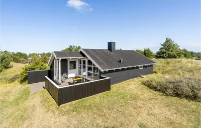 a house on top of a grassy field at Holiday Home Grårisvej Thisted Vi in Thisted