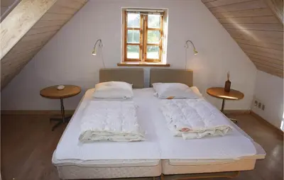 a bedroom with a large bed in a attic at Holiday Home Grønkærvej in Thisted