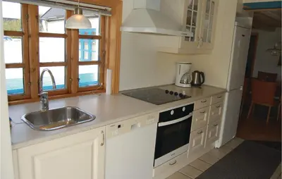 a kitchen with a sink and a stove top oven at Holiday Home Grønkærvej in Thisted