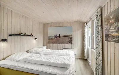 a bedroom with two beds and a view of the beach at Holiday Home Fiskervej Thisted Iv in Thisted