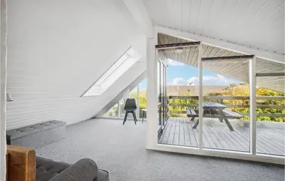a living room with a sliding glass door and a table at Holiday Home Ørredvej Thisted Ii in Thisted