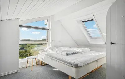 a white bedroom with a bed and a window at Holiday Home Ørredvej Thisted Ii in Thisted