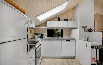 a white kitchen with white cabinets and a skylight at Holiday Home Tranebærvej Thisted Iv in Nørre Vorupør