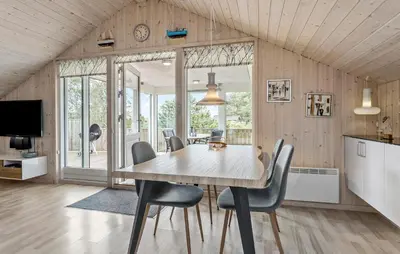 a dining room with a table and chairs at Holiday Home Tranebærvej Thisted Iv in Nørre Vorupør