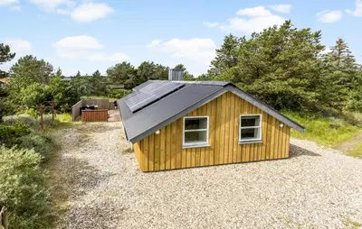 a small yellow building with a black roof at Holiday Home Tranebærvej Thisted Iv in Nørre Vorupør