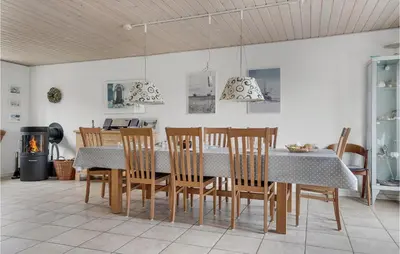a dining room with a table and chairs at Holiday Home Stenbjerg Kirkevej in Snedsted