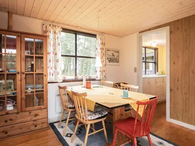 a dining room with a wooden table and chairs at Charming Cottage near Beach - By Traum Ferienwohnungen in Fjerritslev