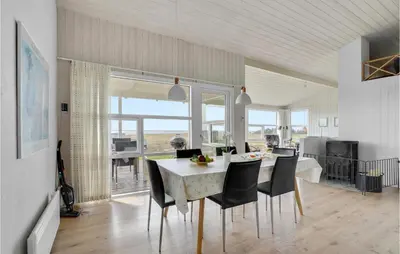 a kitchen and dining room with a table and chairs at Stunning Home In Vestervig With Wifi in Vestervig