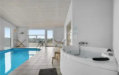 a bathroom with a tub and a swimming pool at Stunning Home In Vestervig With Wifi in Vestervig