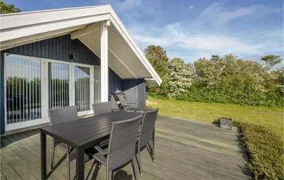 a patio with a table and chairs on a house at Holiday Home Gunhildsvej Vestervig in Vestervig