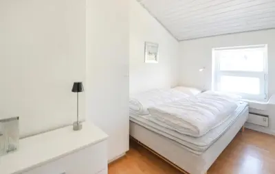 a white bedroom with a bed and a window at Awesome Home In Vestervig With Kitchen in Vestervig