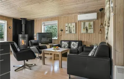 a living room with a couch and chairs and a table at Holiday Home Gunhildsvej Vestervig Xii in Vestervig