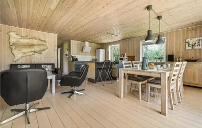 a kitchen and dining room with a table and chairs at Holiday Home Gunhildsvej Vestervig Xii in Vestervig